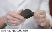 Male hands in gloves holding coal. Стоковое фото, фотограф David Kashakhi / Фотобанк Лори