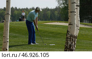 Golfers hit sweeping golf course in the summer. Стоковое фото, фотограф David Kashakhi / Фотобанк Лори