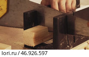 Woodworking technique showing precise cutting of lumber with hand saw in a workshop. Стоковое видео, видеограф Сергей Толмачёв / Фотобанк Лори