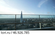 View from the window on the buildings surrounding The Shard skyscraper in the center of London against the blue sky. Стоковое фото, фотограф David Kashakhi / Фотобанк Лори