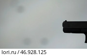 Close profile of man holding a 9 mm handgun, then takes a shot. Стоковое фото, фотограф David Kashakhi / Фотобанк Лори