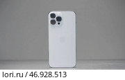 Shenzhen - China, 10.16.2021: iPhone 13 Pro Max with three cameras in silver color. Редакционное фото, фотограф David Kashakhi / Фотобанк Лори