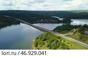 A huge bridge over a large river against the background of a cloudless sky and huge forest trees. Стоковое фото, фотограф David Kashakhi / Фотобанк Лори
