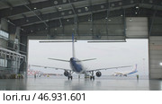 Hangar for aircraft with large open gate at sunny summer day. Стоковое фото, фотограф David Kashakhi / Фотобанк Лори