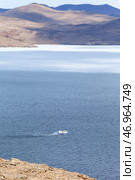 Baikal Lake in spring. Top view of Olkhon Gate Strait and Khivus hovercraft carrying passengers to Olkhon Island during ice drift on windy April day. Natural background. Unusual travels and adventures. Стоковое фото, фотограф Виктория Катьянова / Фотобанк Лори