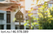 House Keys. Keys from new housing, dwellings among blurred real estate, apartment building. Relocation. Open entrance door, house shaped keychain. Door Keyring. Real estate, agent, insurance, property. Стоковое AI-видео, аниматор Марина Демидюк / Фотобанк Лори