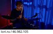 Young man beating drumstick, concept of music learning, happy relaxing time, freedom. Стоковое фото, фотограф David Kashakhi / Фотобанк Лори