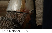 Close up side view of a man in very heavy headdress, middle ages armor concept. Стоковое фото, фотограф David Kashakhi / Фотобанк Лори