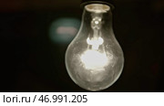 Switching on, turning off light bulb on white wall background. Стоковое фото, фотограф David Kashakhi / Фотобанк Лори