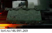 Close up of automated robotic mechanism making circuit board. Стоковое фото, фотограф David Kashakhi / Фотобанк Лори