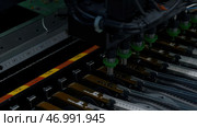 Close up of details of automatic SMD pick and place machine during work. Стоковое фото, фотограф David Kashakhi / Фотобанк Лори