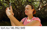 Portrait of female tourist making pictures and videos of surrounding nature. Стоковое фото, фотограф David Kashakhi / Фотобанк Лори