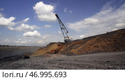 Heavy Machinery Used in OpenPit Mining Operations for Extracting Valuable Minerals and Resources. Стоковое фото, фотограф David Kashakhi / Фотобанк Лори