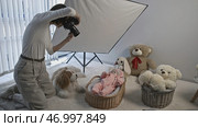 Photosession indoors of a little cute baby in pink warm suit. Стоковое фото, фотограф David Kashakhi / Фотобанк Лори
