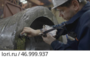 Worker with non-destructive testing device on metal part. Стоковое фото, фотограф David Kashakhi / Фотобанк Лори