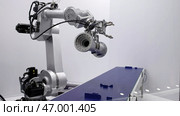 Advanced Robotic Arm Utilized in a Modern Manufacturing Environment with Enhanced Capabilities. Стоковое фото, фотограф David Kashakhi / Фотобанк Лори