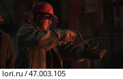 Workers in an Industrial Setting Skillfully Handling Heavy Equipment with Focus and Safety. Стоковое фото, фотограф David Kashakhi / Фотобанк Лори
