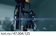 Video highlights a hightech machine and a camera in a dark room. Стоковая иллюстрация, иллюстратор David Kashakhi / Фотобанк Лори