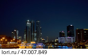 View from the river on the night city with skyscrapers and many lights. Стоковое фото, фотограф David Kashakhi / Фотобанк Лори