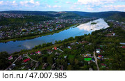Arial view of a small town crossed by a river with a bridge. Стоковое фото, фотограф David Kashakhi / Фотобанк Лори