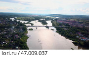 Aerial view of a summer city crossed by a wide river. Стоковое фото, фотограф David Kashakhi / Фотобанк Лори