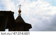 Christian orthodox church building with cross on roof top under cloudy sky low angle shot. Стоковое фото, фотограф David Kashakhi / Фотобанк Лори