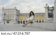 Beautiful lady in white short dress and curly hair. Стоковое фото, фотограф David Kashakhi / Фотобанк Лори