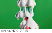 Slow motion of white chocolate is poured onto sweet meringues. Стоковое фото, фотограф David Kashakhi / Фотобанк Лори