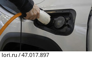 Modern refueling of electric car at gas station. Стоковое фото, фотограф David Kashakhi / Фотобанк Лори