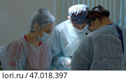 Group of surgeons working in operating room at hospital. Стоковое фото, фотограф David Kashakhi / Фотобанк Лори
