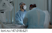 Medical workers performing surgery on a patient under anesthesia. Стоковое фото, фотограф David Kashakhi / Фотобанк Лори