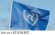 Realistic blue flag waving in the wind on blue background. Стоковая иллюстрация, иллюстратор David Kashakhi / Фотобанк Лори