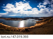 Stunning Landscape With Calm Waters and Dramatic Clouds at Midday Near a Serene Lake. Стоковое фото, фотограф Aleksandr Golubev / Фотобанк Лори