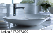 Crisp flowing water from modern faucet into elegant bowl-shaped sink. Вода изящно струится из изящного крана в современную раковину в форме чаши, отражая спокойную и минималистичную атмосферу в ванной комнате. Стоковое AI-изображение, AI-художник Katsiaryna Repich / Фотобанк Лори
