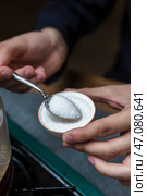 The process of measuring sugar accurately is essential for effective cooking and baking. Стоковое фото, фотограф David Kashakhi / Фотобанк Лори
