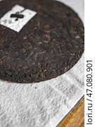 A Detailed CloseUp of a Compressed PuErh Tea Cake, Showcasing its Unique Features and Aroma. Стоковое фото, фотограф David Kashakhi / Фотобанк Лори