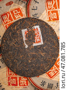 A beautifully compressed Puerh Tea Cake that comes complete with exquisite vintage wrappers. Стоковое фото, фотограф David Kashakhi / Фотобанк Лори