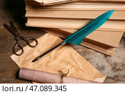 Старые книги с перьевой ручкой, листом бумаги, свитком и ножницами на деревянном фоне. Стоковое фото, фотограф Pixel_shot / Фотобанк Лори