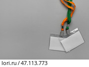 Пустые бейджи с шейным шнурком на сером фоне. Стоковое фото, фотограф Pixel_shot / Фотобанк Лори