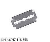 A single metal razor blade is centrally positioned isolated on a plain white background. Стоковое фото, фотограф Елена  Попкова / Фотобанк Лори
