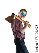 Man in a clown mask holds a rusty big ax on his shoulder. Isolated on a white background. Стоковое фото, фотограф Дмитрий Кобзев / Фотобанк Лори