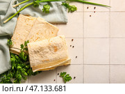 Свежий лаваш на белом фоне из плитки. Стоковое фото, фотограф Pixel_shot / Фотобанк Лори