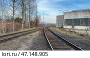 An abandoned railway and industrial site shows historys remnants and natures reclamation. Стоковое видео, видеограф Vladimir Vintonjak / Фотобанк Лори
