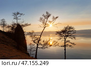 Beautiful calm landscape of Baikal Lake on a May evening. View from the shore of Olkhon Island to the scenic sunset over the Small Sea. Natural background. Spring travels and outdoor recreation. Стоковое фото, фотограф Виктория Катьянова / Фотобанк Лори