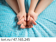 Woman giving herself foot massage, corns and calluses on feet, dry skin on legs. Стоковое фото, фотограф Станислав Тарко / Фотобанк Лори