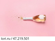 Бутылка шампанского и блестит на цветном фоне. Встреча Нового года. Стоковое фото, фотограф Pixel_shot / Фотобанк Лори