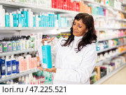 Smiling hispanic saleswoman offering hair care products in shop. Стоковое фото, фотограф Яков Филимонов / Фотобанк Лори