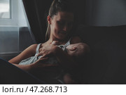 Loving happy mum carrying of newborn baby at home. Стоковое фото, фотограф Aleksandr Golubev / Фотобанк Лори