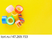 Рулоны клейкой ленты, точилка и ластик на желтом фоне. Стоковое фото, фотограф Pixel_shot / Фотобанк Лори
