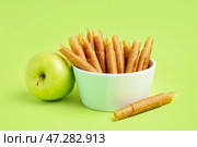 Чаша вкусных яблочных пастилок на зеленом фоне. Стоковое фото, фотограф Pixel_shot / Фотобанк Лори